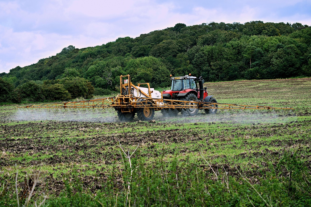tractor spraying field with fertilizer